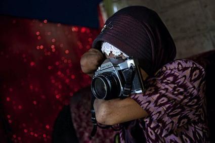 بالرغم من بتر يديها، إندونسية تحترف التصوير